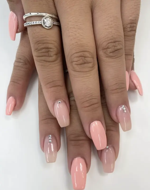 Peach ombre coffin gel nails with silver studs
