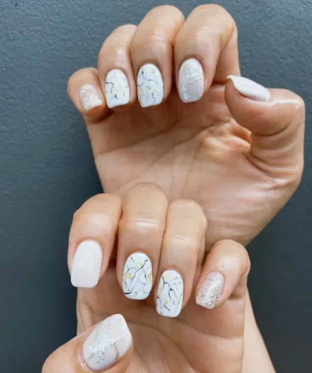 White marble nails with gold foil and glitter accent